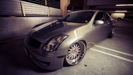 Sleek Silver Coupe in Urban Setting wallpaper