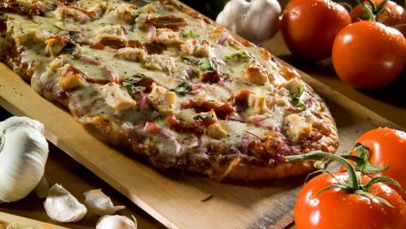 Delicious Pizza with Fresh Ingredients and Herbs wallpaper