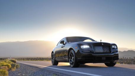 Luxury Black Car Against Scenic Sunrise Background wallpaper