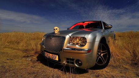 Sleek Silver Car with a Mysterious Twist wallpaper
