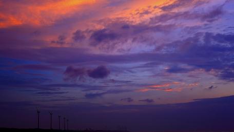 Serene Sunset Over Wind Turbines wallpaper