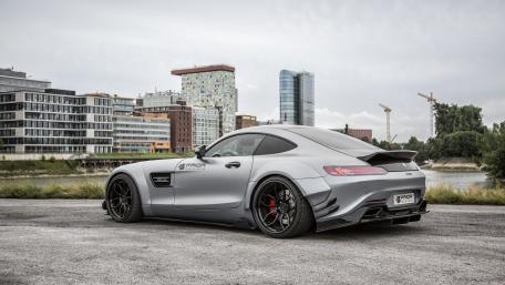 Sleek Gray Sports Car Surrounded by Modern Architecture wallpaper