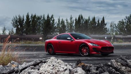 Sleek Red Sports Car in a Dramatic Landscape wallpaper