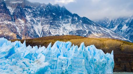 Majestic Glacier Under Mountain Peaks wallpaper