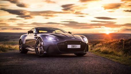 Sleek Aston Martin Against a Breathtaking Sunset wallpaper