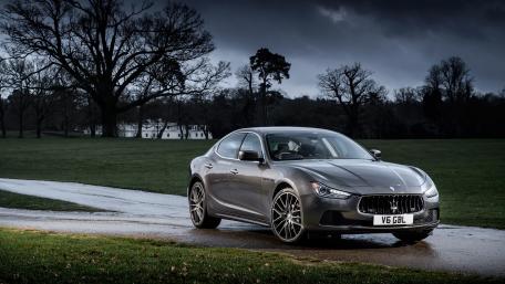 Sleek Luxury Sedan in a Dramatic Landscape wallpaper