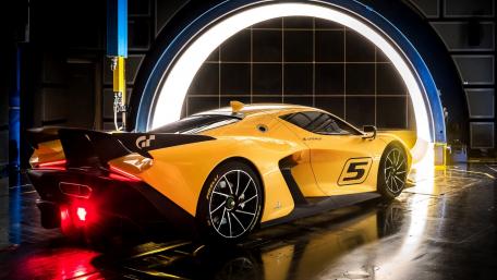 Stunning Yellow Sports Car under Glowing Archway wallpaper