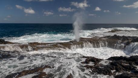 Majestic Ocean Geyser Erupting from the Rocks wallpaper
