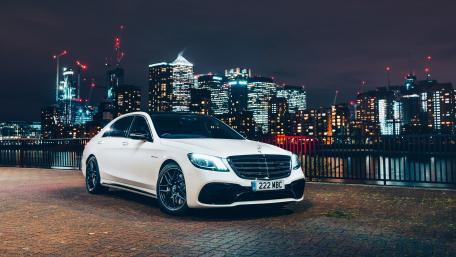 Sleek White Luxury Sports Car in City Night Scene wallpaper