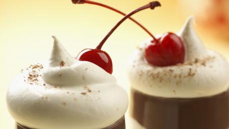 Decadent Chocolate Treats with Whipped Cream and Cherries wallpaper