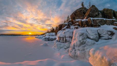 Frozen Serenity at Sunset Over Ice Fields wallpaper