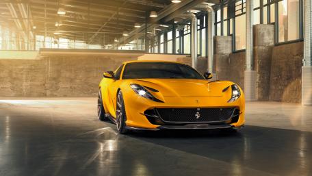 Sleek Yellow Ferrari in an Urban Space wallpaper