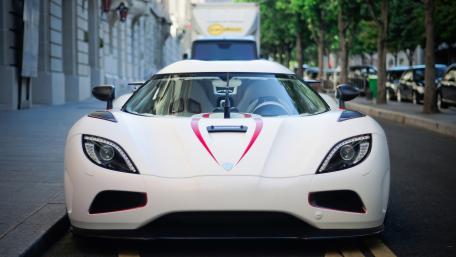 Sleek White Supercar Stands Out on Urban Street wallpaper