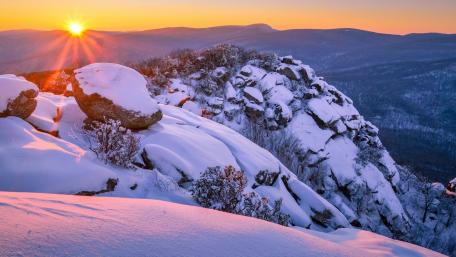 Majestic Winter Sunrise Over Snowy Peaks wallpaper