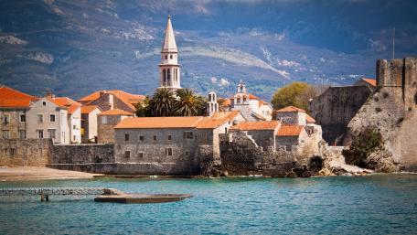 Charming Coastal Village Surrounded by Mountains wallpaper