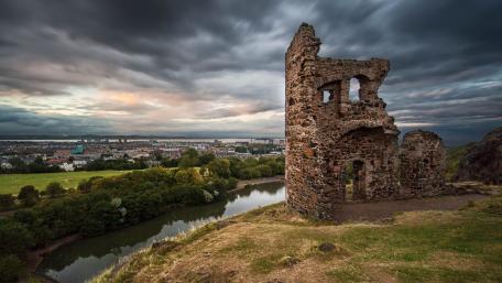 Ancient Ruins Overlooking a Serene Landscape wallpaper