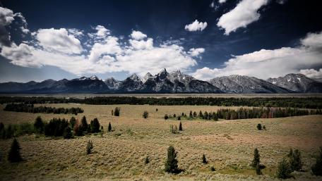 Majestic Mountains Under a Dramatic Sky wallpaper
