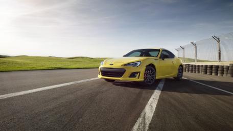 Vibrant Yellow Sports Car on the Track wallpaper