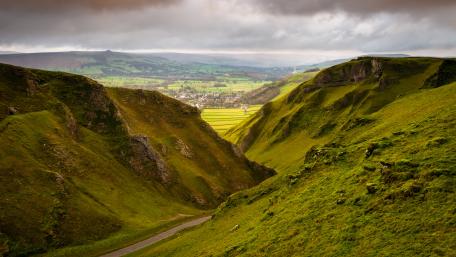 Majestic Green Valley Under Dramatic Skies wallpaper