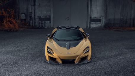 Sleek McLaren Supercar in Urban Setting wallpaper