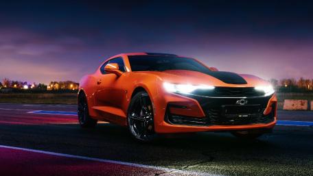 Vibrant Orange Sports Car at Dusk wallpaper