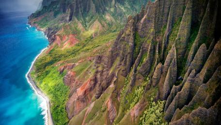 Majestic Coastal Peaks Overlooking Turquoise Waters wallpaper