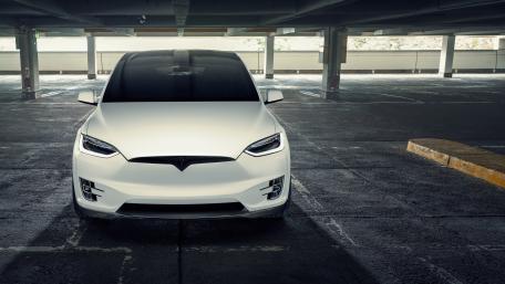 Sleek Electric SUV in an Urban Setting wallpaper