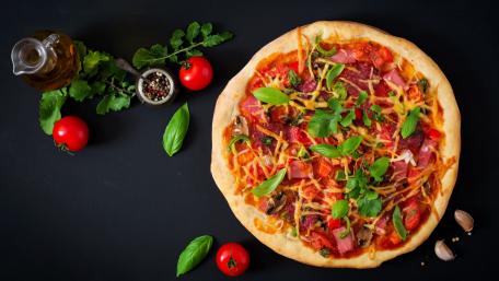 Delicious Homemade Pizza on a Dark Background wallpaper