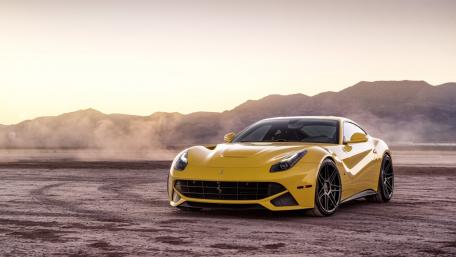 Sleek Yellow Sports Car in Desert Landscape wallpaper