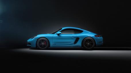 Sleek Blue Sports Car Under Dramatic Lighting wallpaper