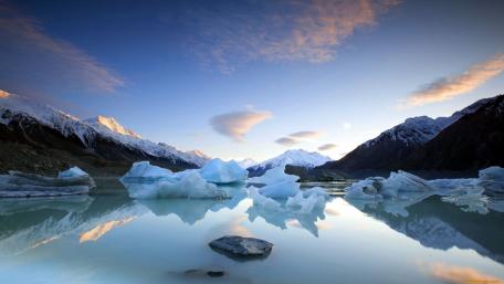 Serene Reflection of Icebergs in Tranquil Waters wallpaper