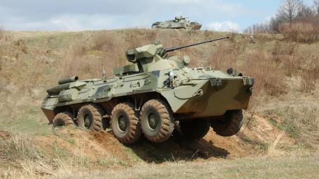Military Vehicle in Action on Rugged Terrain wallpaper