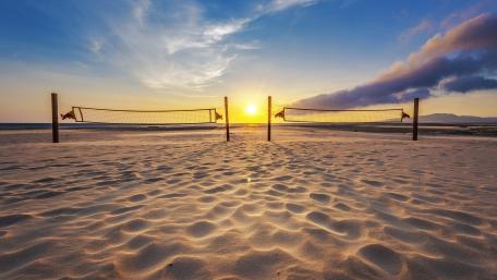 Golden Sunset Over Serene Beach Volleyball Court wallpaper