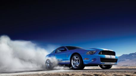 Dynamic Blue Muscle Car in Action wallpaper