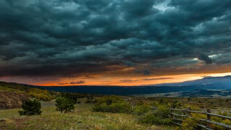 Dramatic Sunset Over Rolling Hills and Clouds wallpaper