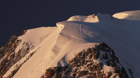Majestic Snow-Capped Peaks Under Twilight Sky wallpaper