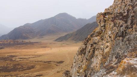 Serene Rocky Landscape Amidst Vast Wilderness wallpaper