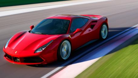 Sleek Red Ferrari Accelerating on the Track wallpaper