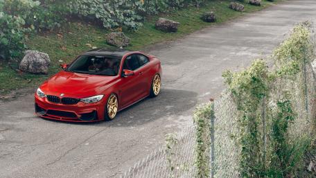 Striking Red BMW on a Scenic Roadway wallpaper