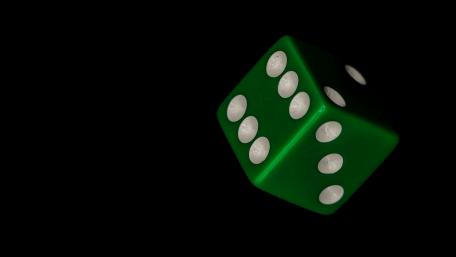 Vibrant Green Die Against Dark Background wallpaper