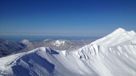 Majestic Snow-Capped Mountains Under Clear Blue Skies wallpaper