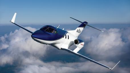 Sleek Jet Soaring Through the Clouds wallpaper