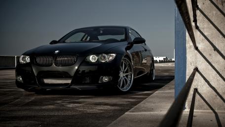 Sleek Black BMW on Urban Rooftop wallpaper