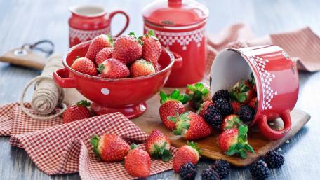 Bountiful Berry Harvest in Vibrant Red Bowls wallpaper