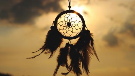Dream Catcher Silhouette Against a Sunset Sky wallpaper