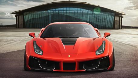 Sleek Red Sports Car in Dynamic Setting wallpaper