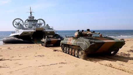 Military Transport on Shoreline at Dawn wallpaper