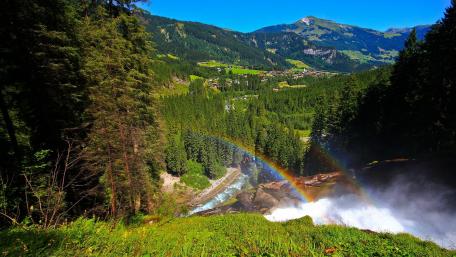 Vivid Rainbow Over Serene Mountain Landscape wallpaper