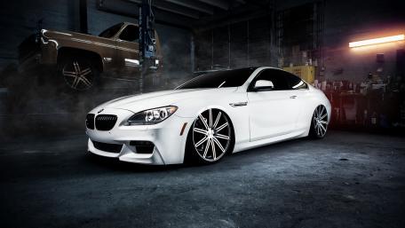 Sleek White BMW in a Stylish Garage Setting wallpaper