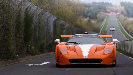 Dynamic Racing Machine on a Scenic Track wallpaper